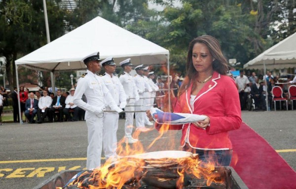 Vicealcaldesa Raisa Banfield llevando la bandera al fuego.