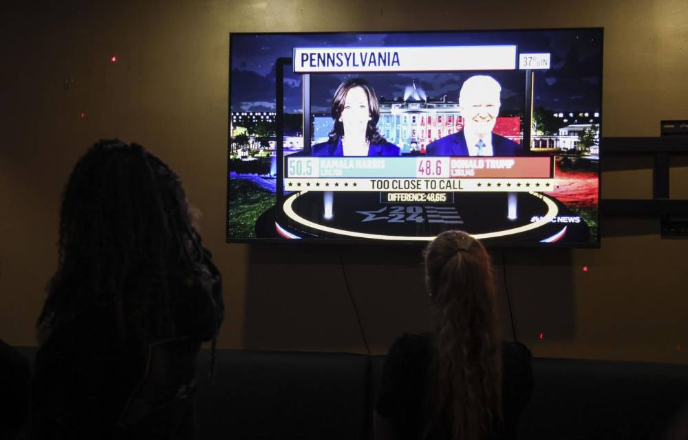 La gente observa cómo se informan los resultados de la votación en las elecciones presidenciales de 2024 por televisión en un bar en Nueva York, Nueva York, EE.UU., el 5 de noviembre de 2024. EFE/SARAH YENESEL