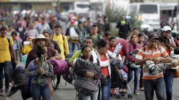 Miembros de la caravana migrante llegan al albergue de la iglesia de la Asunción, en la ciudad de Puebla.