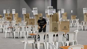 Una persona prepara un puesto de votación este sábado. EFE/ Carlos Ortega