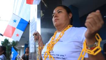 La docente Ivin Henríquez se encadenó en la Defensoría del Pueblo para exigir una respuesta sobre la situación de los docentes separados.