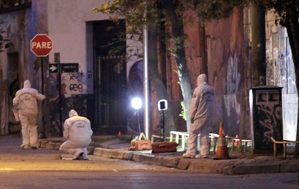 Personal de la policía forense buscó evidencias en el sitio donde un artefacto explosivo estalló en el centro de Santiago.