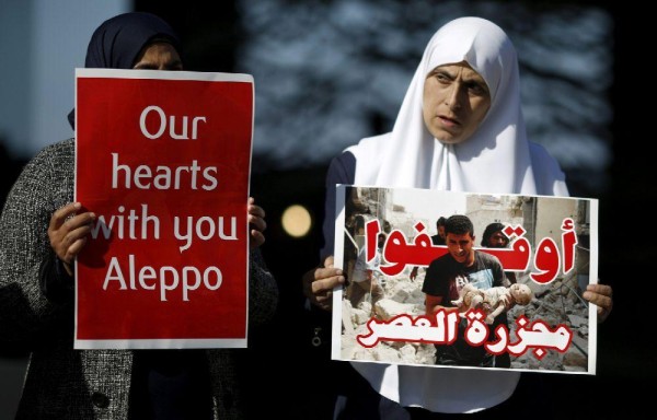 Mujeres árabes sostienen pancartas en apoyo a las víctimas de los bombardeos
