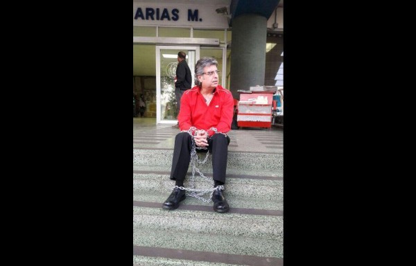 El presidente de la Fundación Probidsida encadenado frente al complejo hospitalario, como medida de protesta por la falta de Raltegravir y Atripla.