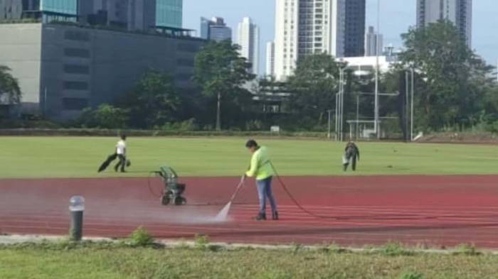 Personal técnico continúa con la limpieza de la pista de atletismo para garantizar condiciones óptimas tras las intensas lluvias.
