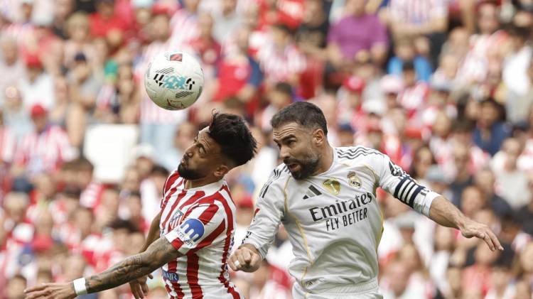 El delantero argentino del Atlético de Madrid Nico González (i) pelea un balón ante el lateral del Real Madrid Dani Carvajal durante el partido de liga entre el Real Madrid y el Atlético de Madrid que se disputó en el estadio Riyadh Air Metropolitano este sábado.