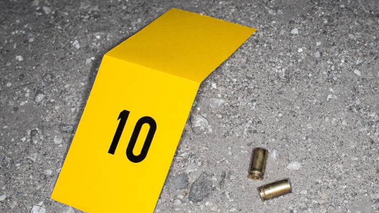 Crime Evidence Photo Taken By Forensics at Crime scene: Bullet Shells Found Next to a Body of Victim Shot Dead. Caliber Needs to be Compared to the Murder Weapon. Realistic Picture For Police Show
